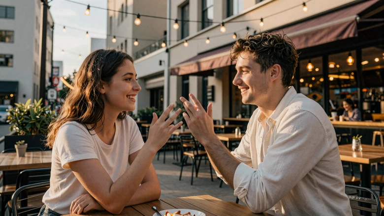 Deaf couple communicating in American Sign Language at an outdoor cafe during golden hour